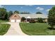 Charming brick home features a manicured lawn, a wide driveway, and an attached two-car garage at 139 Hardwick Dr, Mooresville, NC 28115