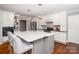 Bright kitchen featuring an island with counter seating, modern appliances, and white cabinetry at 139 Hardwick Dr, Mooresville, NC 28115