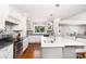 Bright kitchen featuring white cabinetry, stainless steel appliances, and a spacious center island with pendant lighting at 139 Hardwick Dr, Mooresville, NC 28115