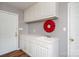 This laundry room features white cabinets and a sink with a decorative wreath at 139 Hardwick Dr, Mooresville, NC 28115