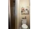 Neutral bathroom features a floral hummingbird art piece above the toilet and a shower with curtain at 140 Lake Concord Ne Rd, Concord, NC 28025