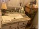 Elegant bathroom sink featuring granite countertops, white cabinetry, and stylish decor at 140 Lake Concord Ne Rd, Concord, NC 28025