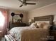 Charming bedroom featuring a plush bed, dresser with a mirror, and tasteful decor at 140 Lake Concord Ne Rd, Concord, NC 28025