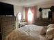 Serene bedroom featuring a plush bed, dual dressers with mirrors, and soft, natural lighting at 140 Lake Concord Ne Rd, Concord, NC 28025