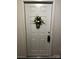 Apartment front door painted bright white with a decorative floral decoration at 140 Lake Concord Ne Rd, Concord, NC 28025