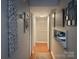 Hallway showing decorative wall art, hardwood floors, and an open view into other living spaces at 140 Lake Concord Ne Rd, Concord, NC 28025