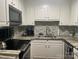 Modern kitchen with granite countertops, tiled backsplash, and stainless steel appliances at 140 Lake Concord Ne Rd, Concord, NC 28025