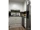Well-lit kitchen with white cabinets, stainless steel appliances, and a gray tile backsplash at 140 Lake Concord Ne Rd, Concord, NC 28025
