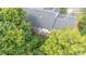 Back aerial view of townhomes showcasing their decks, mature trees, and green surroundings at 14664 Lions Paw St, Charlotte, NC 28273