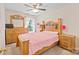 Bedroom featuring a wood bed frame, wood dresser, and a large window with curtains at 14664 Lions Paw St, Charlotte, NC 28273