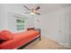 Sunlit bedroom boasts neutral colors, a ceiling fan, and a peaceful ambiance at 14664 Lions Paw St, Charlotte, NC 28273