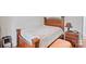 Comfortable bedroom with wooden bed frame, quilt, and bedside table with lamp at 14664 Lions Paw St, Charlotte, NC 28273