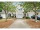 A well manicured townhome with a single car garage and black front door at 14664 Lions Paw St, Charlotte, NC 28273
