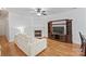 Cozy living room with a fireplace, media center, and hardwood floors at 14664 Lions Paw St, Charlotte, NC 28273