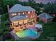 Aerial view of the backyard featuring a kidney-shaped pool, outdoor seating, and lush landscaping, perfect for entertaining at 159 Carsons Pl, Mooresville, NC 28117