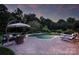Relaxing patio area with comfortable seating, shade umbrella, and lush landscaping, creating a serene outdoor oasis at 159 Carsons Pl, Mooresville, NC 28117