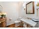 Stylish half-bathroom featuring shiplap walls, marble countertops, and modern brass fixtures at 159 Carsons Pl, Mooresville, NC 28117