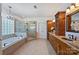 Luxurious bathroom with a soaking tub, glass-enclosed shower, and dual vanity with granite countertops at 159 Carsons Pl, Mooresville, NC 28117