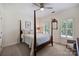 Inviting bedroom featuring a four-poster bed, hardwood floors and natural light at 159 Carsons Pl, Mooresville, NC 28117
