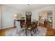 Elegant dining room with hardwood floors, stylish light fixture, and access to the gourmet kitchen at 159 Carsons Pl, Mooresville, NC 28117
