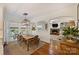 Bright dining room with hardwood floors, a modern light fixture, and an open layout to the living room at 159 Carsons Pl, Mooresville, NC 28117