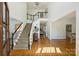 Grand foyer with a staircase, hardwood floors, and natural light, offering a bright and welcoming entry at 159 Carsons Pl, Mooresville, NC 28117