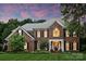 Elegant brick home showcasing manicured landscaping and a welcoming front porch, set against a colorful dusk sky at 159 Carsons Pl, Mooresville, NC 28117