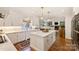 Spacious kitchen with white cabinetry, marble countertops, a central island, and views into the adjacent living spaces at 159 Carsons Pl, Mooresville, NC 28117