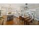 Bright and airy kitchen featuring white cabinetry, stainless steel appliances, a large island, and stylish lighting fixtures at 159 Carsons Pl, Mooresville, NC 28117
