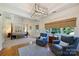 Bright main bedroom boasts a four-poster bed, sitting area, and ample natural light from large windows at 159 Carsons Pl, Mooresville, NC 28117