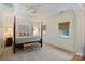 Spacious main bedroom featuring a four-poster bed, tray ceiling, and bright windows at 159 Carsons Pl, Mooresville, NC 28117