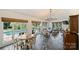Spacious sunroom with stone floors, large windows overlooking the pool, and comfortable seating area at 159 Carsons Pl, Mooresville, NC 28117