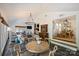 Bright and open sunroom with a stone floor, a large chandelier, and access to other living areas at 159 Carsons Pl, Mooresville, NC 28117