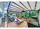 Relaxing back deck with a lounger, dining area, and retractable awning for shade, overlooking a wooded area at 1604 Trentwood Dr, Fort Mill, SC 29715