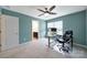 Bright bedroom with a ceiling fan, carpet, desk, and an ensuite bath at 1604 Trentwood Dr, Fort Mill, SC 29715