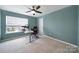 Bright bedroom with a ceiling fan, carpet, and a desk set by the window at 1604 Trentwood Dr, Fort Mill, SC 29715