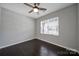 Clean, well-lit bedroom featuring a modern ceiling fan, neutral walls, and a large window at 1604 Trentwood Dr, Fort Mill, SC 29715