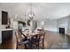 Open layout with dining area, kitchen, and living room, all with hardwood floors and neutral paint at 1604 Trentwood Dr, Fort Mill, SC 29715