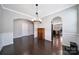 Open dining room with dark wood floors, wainscoting, and access to the kitchen at 1604 Trentwood Dr, Fort Mill, SC 29715