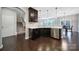 Open kitchen layout with stainless steel dishwasher and dark cabinets next to stairway at 1604 Trentwood Dr, Fort Mill, SC 29715