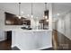 Modern kitchen with white countertops, stainless steel appliances, and dark wood cabinetry at 1604 Trentwood Dr, Fort Mill, SC 29715