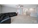 Spacious living room featuring a sectional couch, ceiling fan, and neutral paint at 1604 Trentwood Dr, Fort Mill, SC 29715