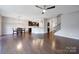 Open-concept living room flows into modern kitchen, boasting hardwood floors and ample natural light at 1604 Trentwood Dr, Fort Mill, SC 29715
