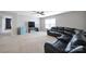 Cozy carpeted living room featuring a sectional couch, ceiling fan, and large window at 1604 Trentwood Dr, Fort Mill, SC 29715