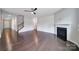 Clean living room with dark wood floors, a corner fireplace, and a ceiling fan at 1604 Trentwood Dr, Fort Mill, SC 29715
