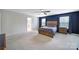 Comfortable main bedroom featuring a wood bed frame, blue accent wall, and ensuite bath at 1604 Trentwood Dr, Fort Mill, SC 29715