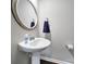 Charming powder room with pedestal sink, decorative mirror, and neutral wall color at 1604 Trentwood Dr, Fort Mill, SC 29715