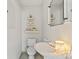 Compact bathroom with modern fixtures, decorative shelves, and minimalist design at 1627 33Rd Ne Ave, Hickory, NC 28601