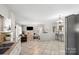 Open-concept living space with tiled floors, brick fireplace and views of the kitchen at 1627 33Rd Ne Ave, Hickory, NC 28601