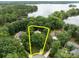 Aerial view of a home nestled in a lush green neighborhood close to a beautiful lake at 165 Futrell Lndg, New London, NC 28127